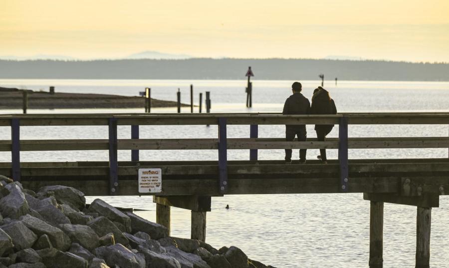 People walking on the pier at Blackie Spit Park in Crescent Beach