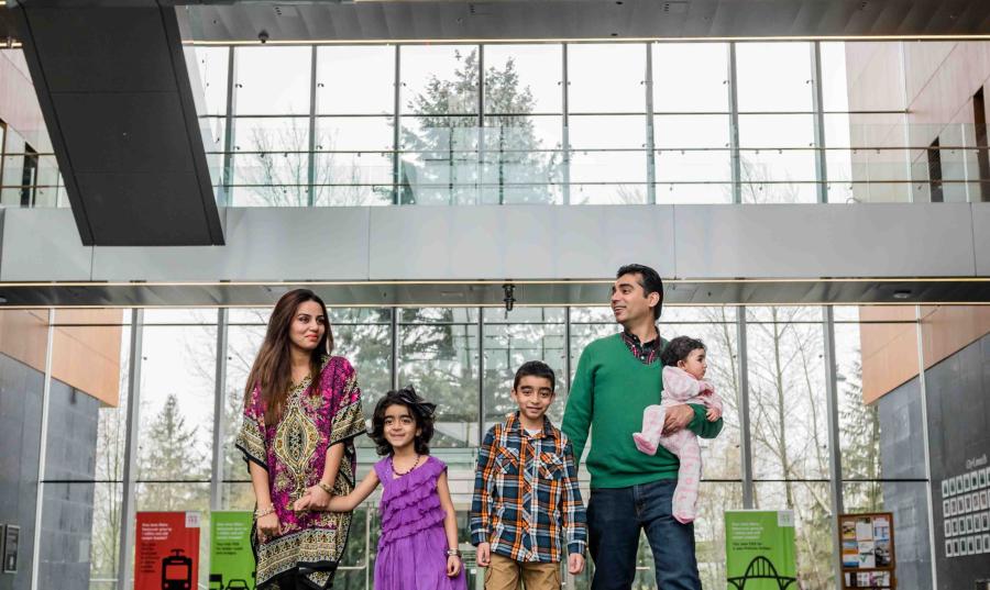 A family walks through Surrey City Hall