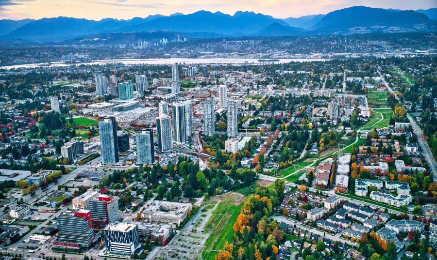Aerial view of Downtown Surrey with mountains in the background