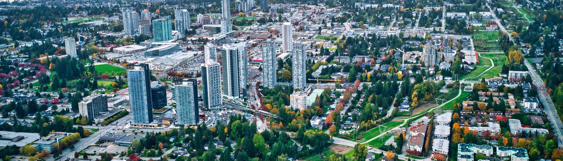 Aerial view of Downtown Surrey with mountains in the background